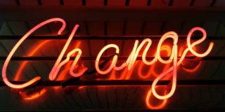 neon sign with the word change