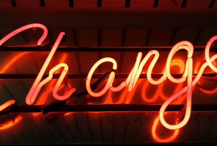 neon sign with the word change