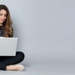 Woman sitting on the floor with a laptop