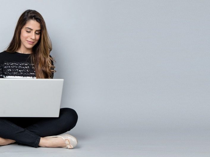 Woman sitting on the floor with a laptop