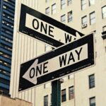 New York 'one way' signs pointing in opposite directions